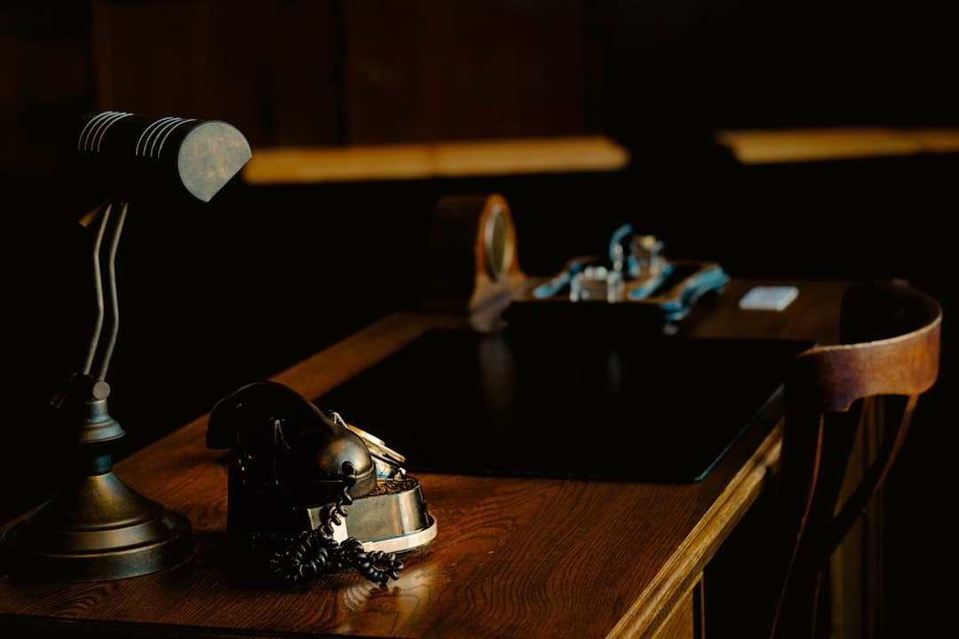 A stethoscope and notebook on a wooden desk in natural light.