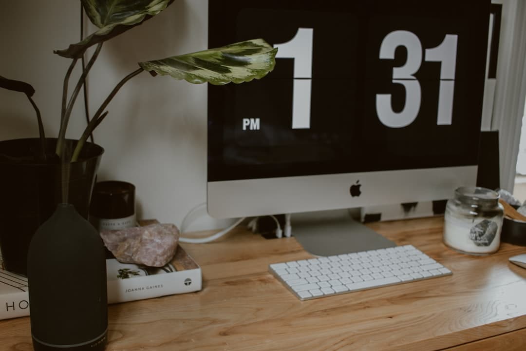 A wall calendar beside a wooden desk in morning light.